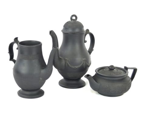 A late 18th/early 19th Century basalt ware teapotOf squat circular form, relief decoration with floral motifs, height 7cm, tw