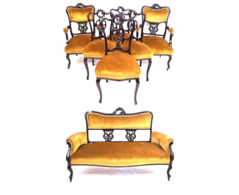 An Edwardian seven piece salon suiteThe two seater sofa, pair of open sided armchairs, and four occasional chairs all featuri