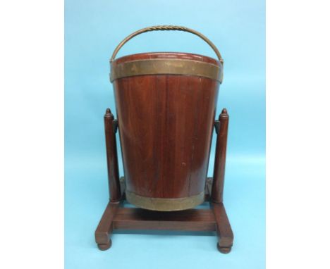 A 19th century mahogany Irish peat bucket on a swivel stand by James Hicks of 5 Lower Pembroke Street, Dublin, 38cm diameter,