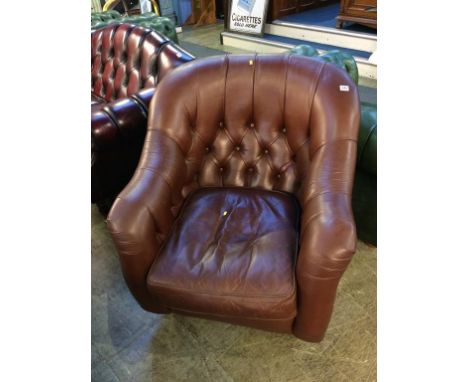 A brown leather button back chair by Laura Ashley 