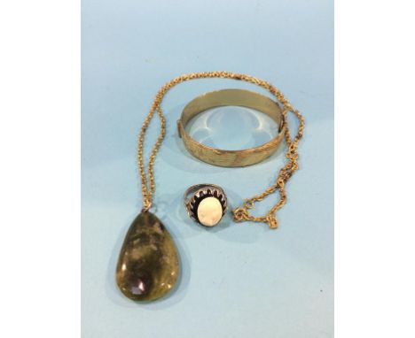 A yellow metal bangle, cameo ring and a pendant