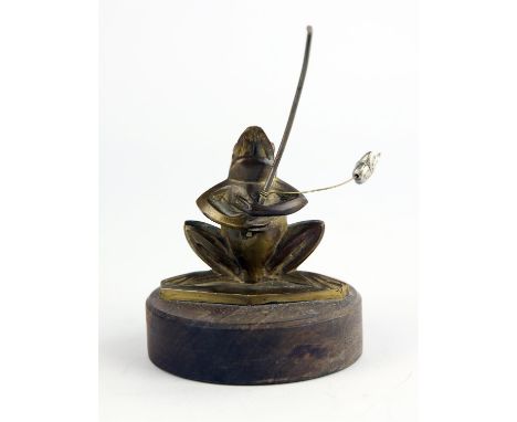 Vintage brass fishing frog car mascot stamped Bizette mounted on wood base. 10cms tall. Please note this lot has the standard