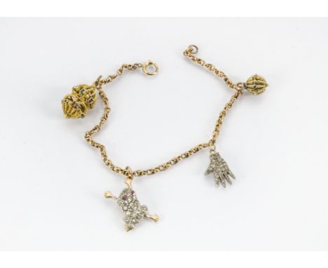 A 9ct gold fancy link bracelet, with four gem set charms including a diamond encrusted hand set in white metal, possibly plat