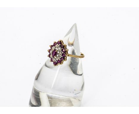 A 9ct gold ruby and diamond oval cluster ring, the oval mixed cut central ruby surrounded by a band of eight cut diamonds and