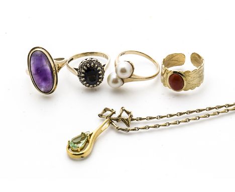 Three gold gem set dress rings, comprising an amethyst cabochon, ring size J, a sapphire and diamond 9ct gold cluster, ring s