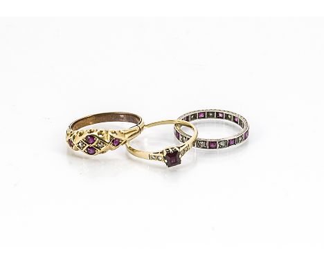 Three ruby and diamond set rings, comprising a white metal eternity band set with step cut rubies and eight cut diamonds, rin