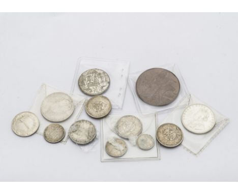 A small group of Victorian and George V India related coins, together with two silver coloured portrait medallions and an WWI