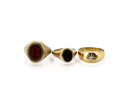 Three gentleman's signet rings, including a 9ct gold garnet set example, ring size O, a 9ct gold onyx example, ring size I an