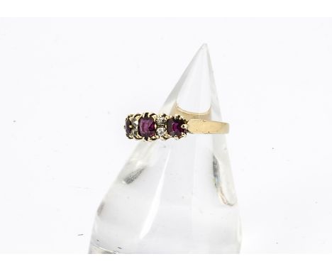 A ruby and diamond dress ring, the three oval mixed cut rubies in claw setting alternately set with two pairs of old cut diam