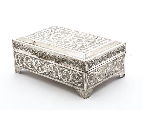 An Art Deco period Middle Eastern silver cigarette box, on four bracket supports having engraved scrolling foliage designs, 1