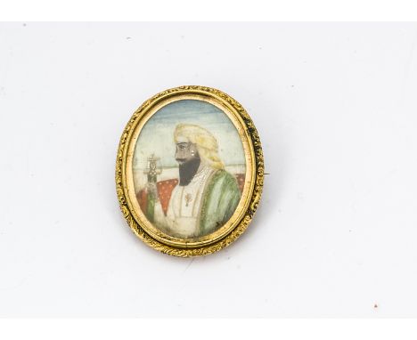 A 19th Century yellow metal miniature brooch, centred with a three quarter length portrait in profile of an Indo Persian gent