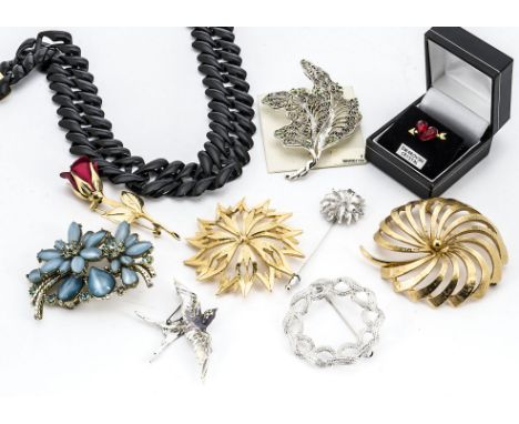 A quantity of signed costume jewellery, by Monet, Trifari, Swarovski etc 