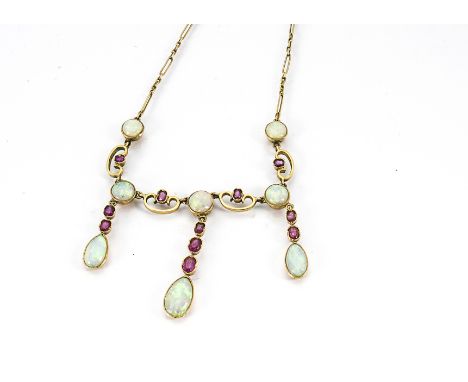 A 9ct gold opal and ruby fringe necklace, the cabochon circular opals interspersed with baguette cut rubies within swag mount