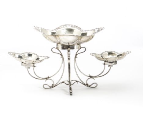 An Edwardian silver sweetmeat stand by James Dixon & Sons, having three quatrefoil pierced rim dishes sitting on a scroll wor