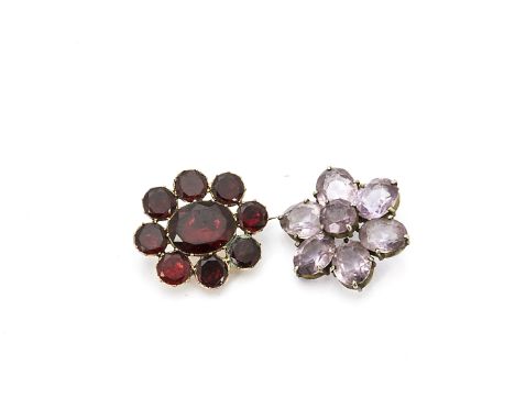 A 19th Century foil backed gilt metal garnet brooch, with pin back of oval form with large mixed cut centre stone surrounded 