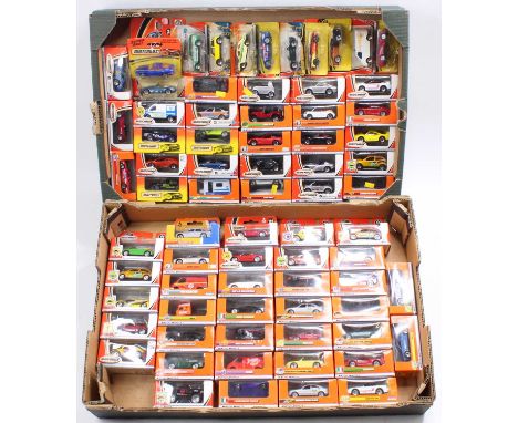 Two trays containing a large collection of various Matchbox Mattel wheels, boxed and carded diecast vehicles to include a Pol