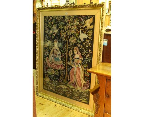 Large gilt framed tapestry depicting two ladies in woodland with birds, 147.5cm by 114cm overall
