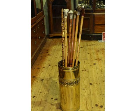 Brass stick stand and six walking sticks