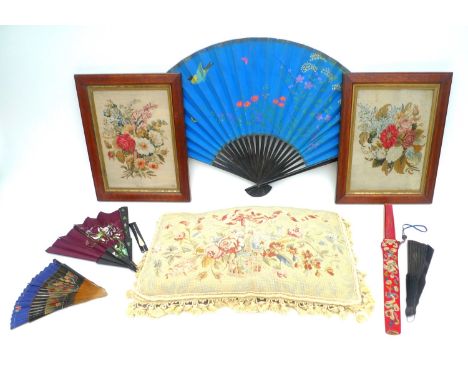 A pair of late 19th/early 20th century wool work embroideries in tent stitch on canvas ground, depicting floral sprays, each 