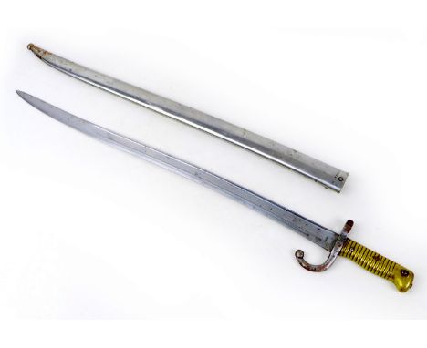 A French 1874 pattern bayonet and scabbard, with hooked quillon guard, brass grip, 'Mre. d'Armes de St. Etienne 1874' engrave