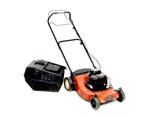 A Champion 375 petrol lawnmower, with Briggs & Stratton engine, red with black grass box.Notes: not known whether in working 