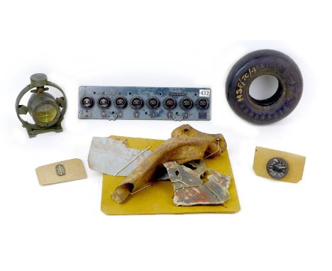 A collection of unidentified WWII aircraft relics, including an Allied control panel with labelled 'Station A', 'Station B' a