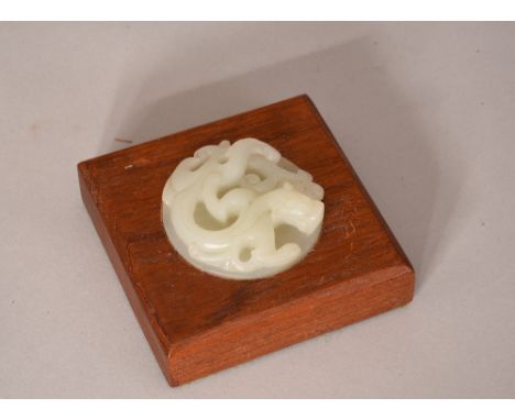 Chinese wooden square scroll weight inlaid with a jade 'dragon' disc, 8.5cm wide.    Please check condition before bidding