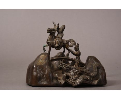Chinese bronze brush rest cast with am immortal standing on the back of dragon and holding a shoe while a bearded scholar rid