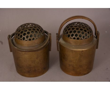 A pair of Chinese bronze cylindrical hand warmers and pierced covers, 22cm high. (2)   Please check condition before bidding
