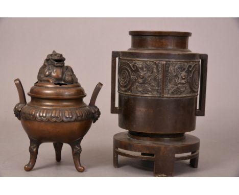 C19th Oriental bronze tripod incense burner and a domed cover with a Buddhist lion finial, 19.8cm high; together with a bronz