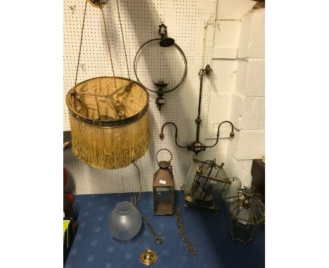A pierced brass fender and various light fittings  various lanterns and hanging pendants with shades