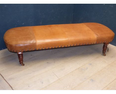 Victorian long stool upholstered in light tan leather on turned mahogany legs to castors 38H x 180W cm