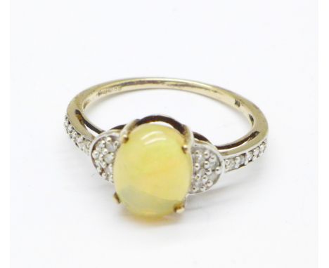 A 9ct gold and opal ring with diamond shoulders, 1.9g, N