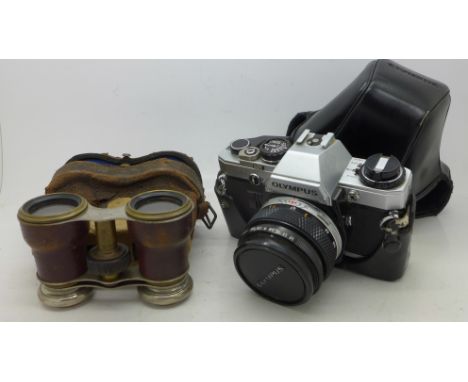 An Olympus OM10 35mm camera and a pair of binoculars marked The Touring Club, case a/f