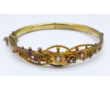 A Victorian 9ct gold, diamond and ruby bangle, Birmingham 1896, 9.7g, mark worn