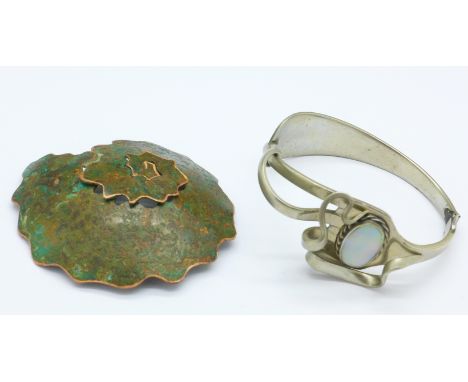 An Arts and Crafts copper brooch and a hand crafted bracelet made out of a fork
