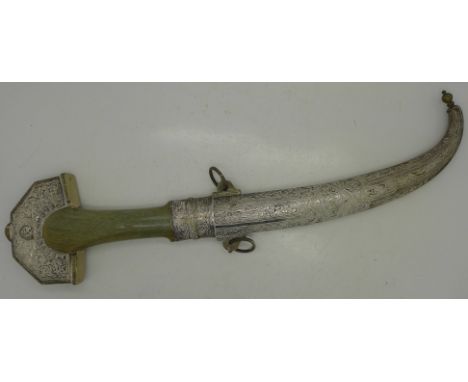 A Persian dagger with horn handle, white metal mounts and scabbard, the blade marked Patent