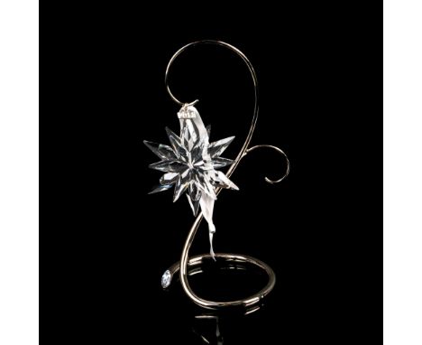 This limited-edition Swarovski Christmas ornament features six short and six long extensions and a metal tag etched 2011, was