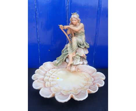A ROYAL DUX PORCELAIN SHELL CENTREPIECE; A HARPIST MAIDEN seated on rocks, over a large shell, pink triangle mark 'Royal Dux 