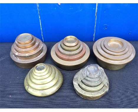 FIVE SETS, OR NEAR SETS, OF STACKING BRASS WEIGHTS for scales