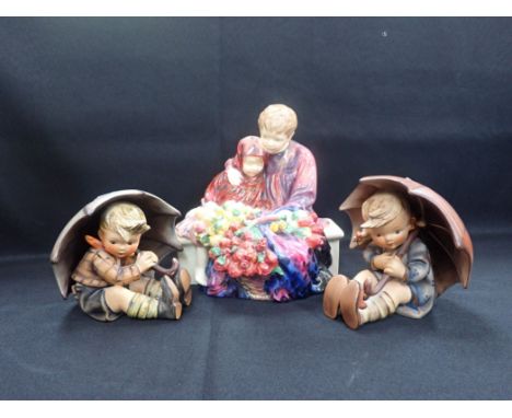 A PAIR OF GOEBEL HUMMEL UMBRELLA FIGURINES 13cm high, and a Royal Doulton 'Flower seller's children' HN 1342 (3)