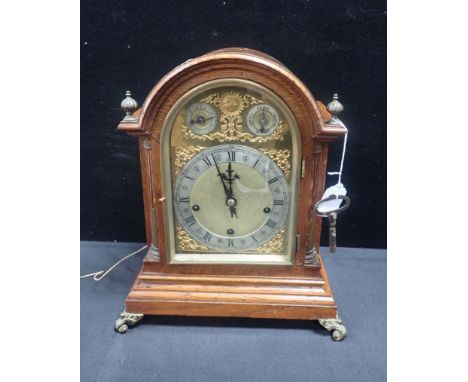 AN OAK-CASED BRACKET CLOCK BY WINTERHALDER &amp; HOFMEIER with Westminster chime and strike on five coiled gongs, the arched 