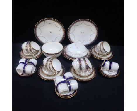 AN EDWARDIAN COPELAND'S PART TEA SERVICE decorated in blue and gilt, on a wrythen body, for twelve (one cup, plate and muffin