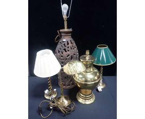 A LARGE PIERCED POTTERY LAMP, A BRASS LAMP of baluster form, a pair of converted spiral brass candlesticks, and a brass 'shel