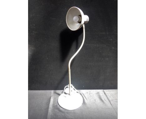 A MID-CENTURY POLISH INDUSTRIAL DESK LAMP adjustable, on heavy cast-iron base, the base 24cm diam