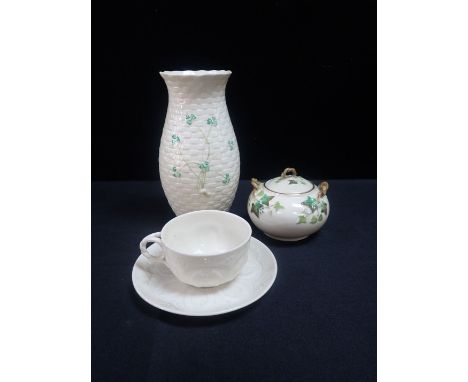 A BELLEEK FIRST PERIOD PORCELAIN INSTITUTE PATTERN CUP AND SAUCER a Belleek third period lidded sucriere and a modern Belleek