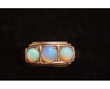 Yellow metal ring tested for gold set with 3 opals