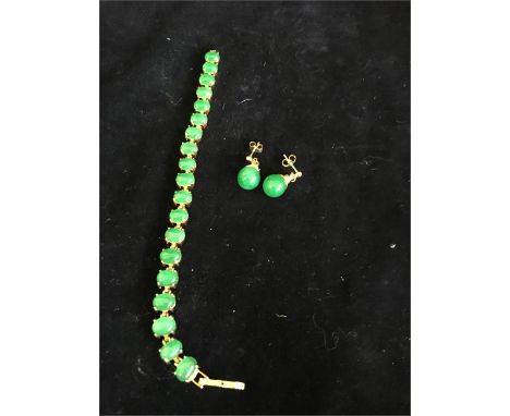 A Jade bracelet set in 9ct gold with a pair of Jade earrings