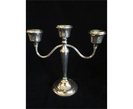 A silver three prong candlestick by ATC, hallmarked Birmingham 