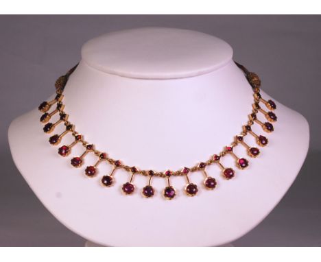 each link in the from a diamond and a flowerhead each centred with a ruby, attached to a silk rope necklace
